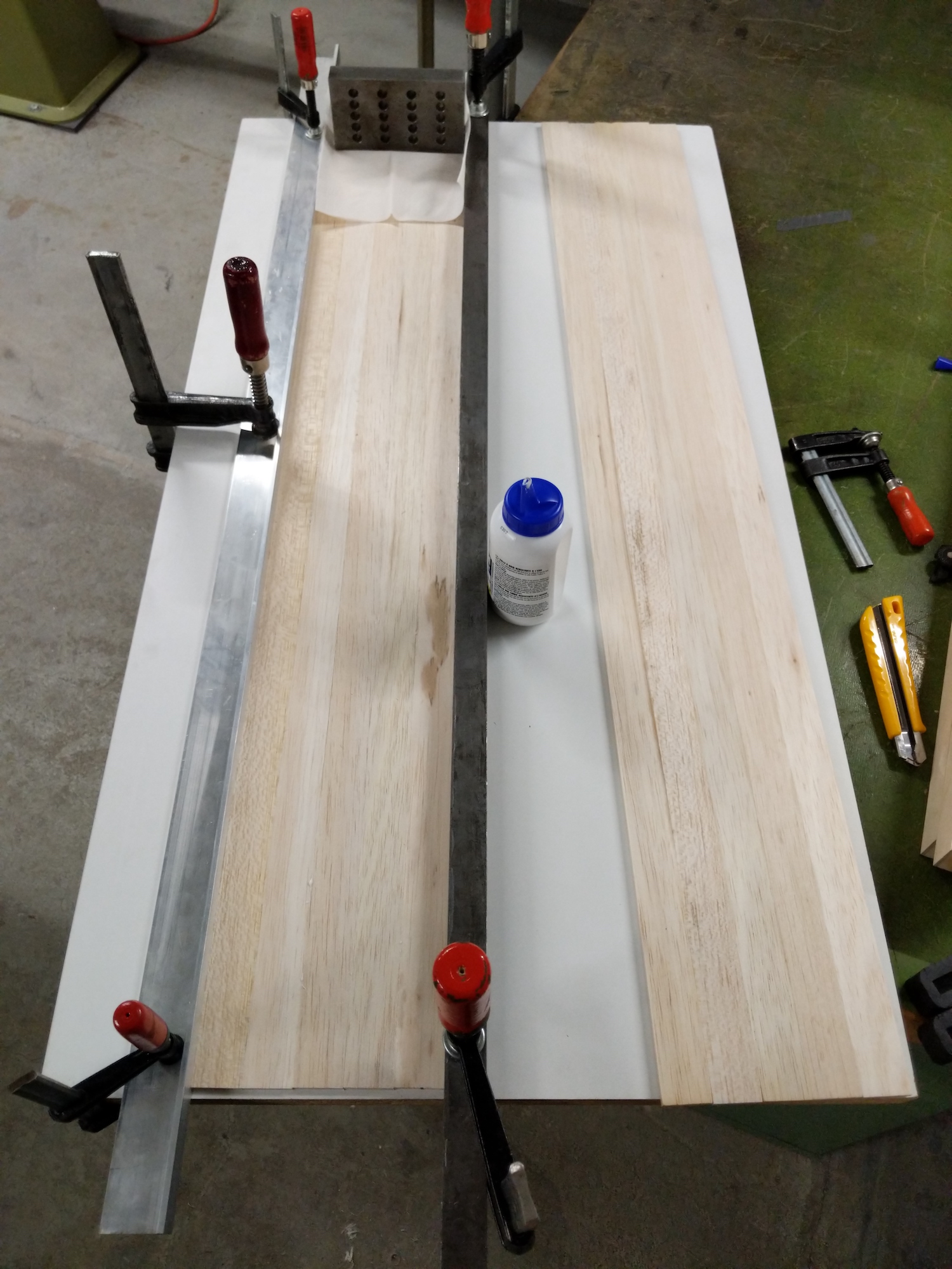 Gluing of the balsa bars to form the deck of the surfboard